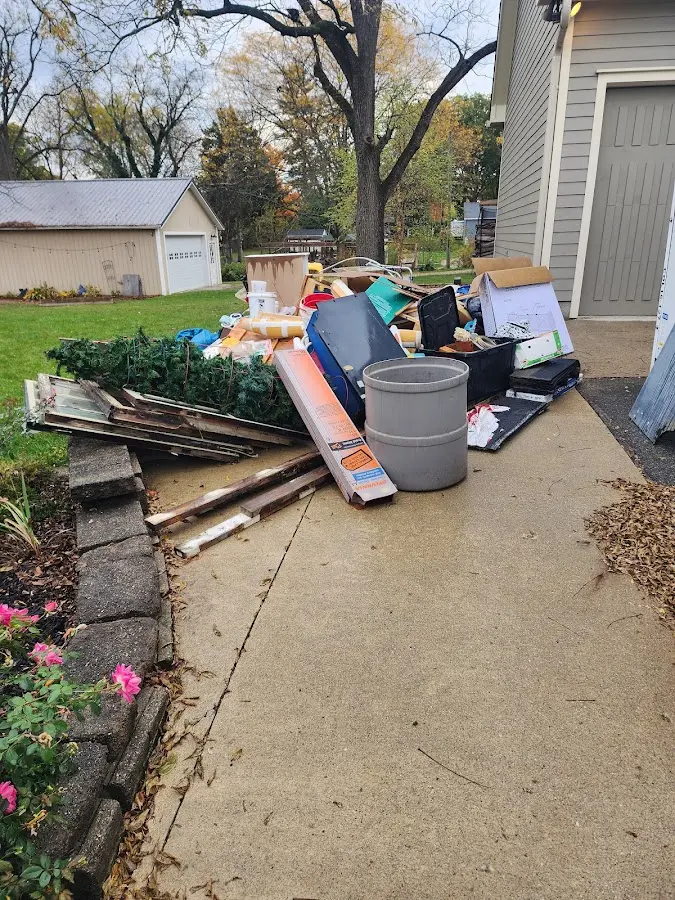 Dumpster being loaded with debris for Estate Cleanout Dumpster Rental in Northlake